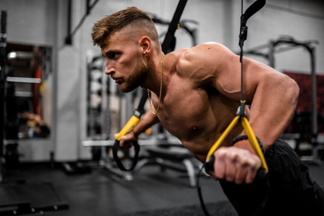 Fit man doing upper-body resistance exercise