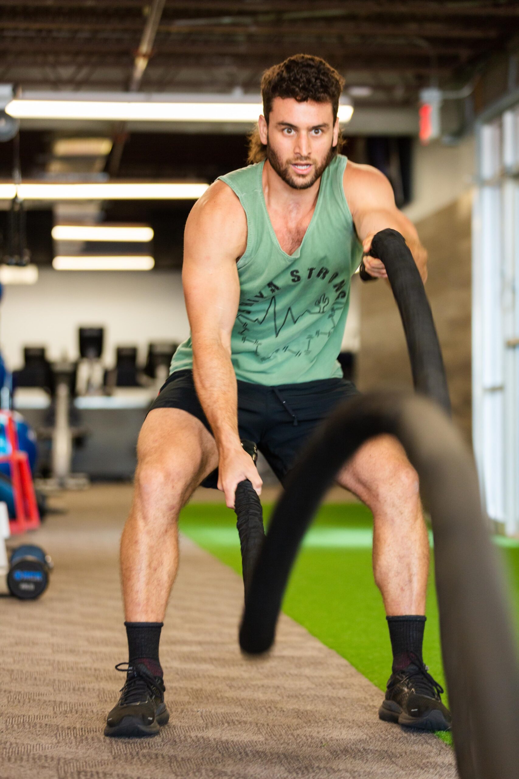 Man using battle ropes for rehabilitation treatment at Launch Physical Therapy