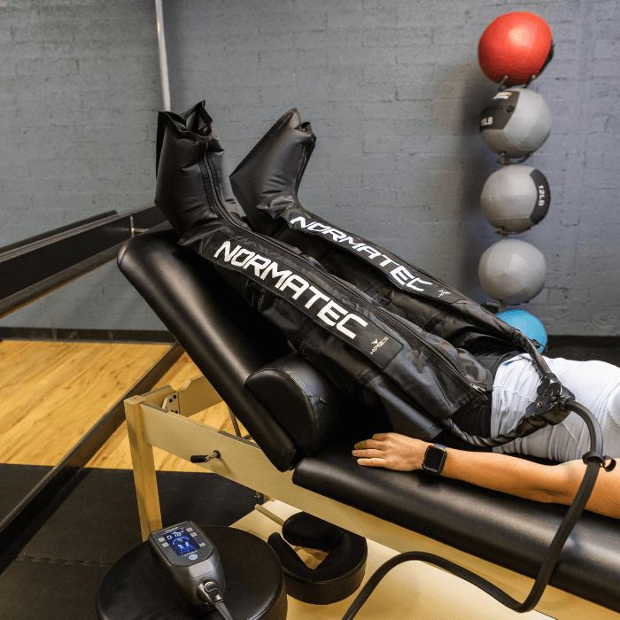 Patient undergoing Normatec System treatment in Phoenix az at Launch Phsyical Therapy