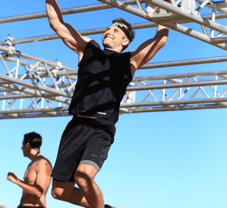 Dr. Zach Biesinger focusing while completing an outdoor obstacle