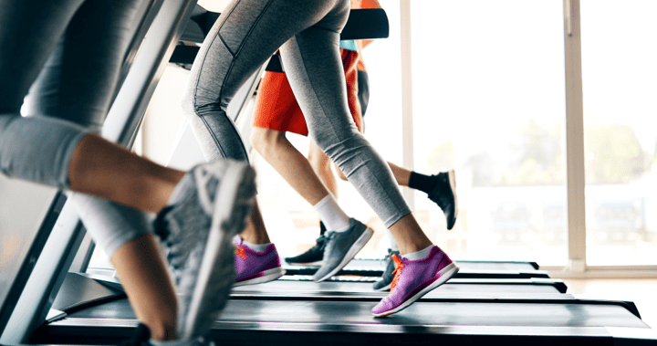 Picture of a group of women running on their own individual treadmills.